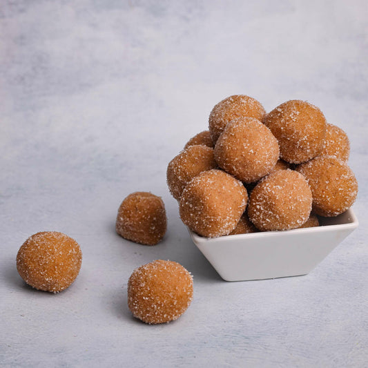 Dharwad Peda on a plate: "A plate of freshly made Dharwad Peda, a traditional Indian sweet, showcasing its soft texture and rich color."