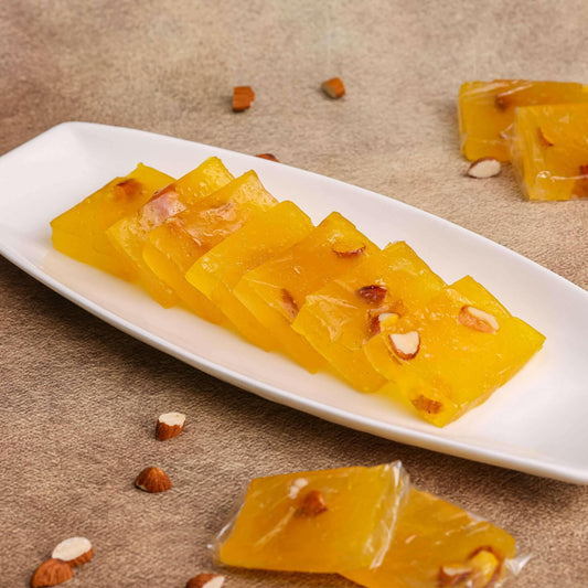 Traditional Indian Dry Fruit Halwa served on a decorative plate with a side of fresh fruit