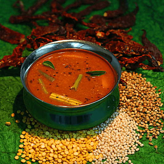 Sambar Powder on a Wooden Spoon: "A wooden spoon holding Sambar powder, highlighting its granular texture against a natural wood background." Spices Online